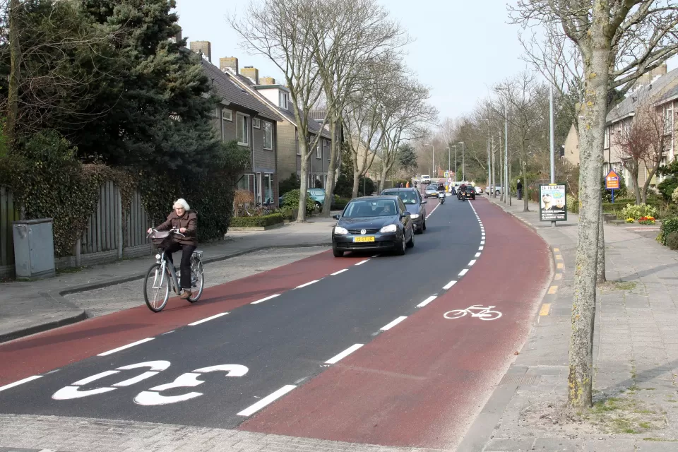 Advisory bike lane in The Netherlands with bike rider and cars in center lane